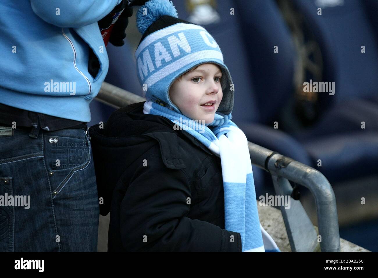 A young Manchester City fan in the stands Stock Photo
