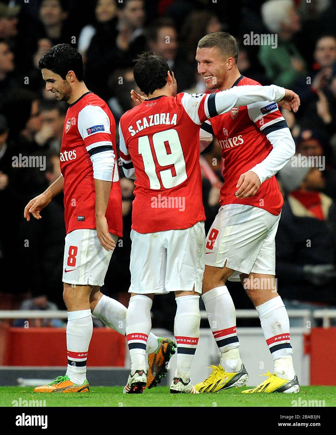Arsenal's Lukas Podolski (right) celebrates with team-mates Santi Cazorla  (centre) and Mikel Arteta after scoring his side's second goal of the game  Stock Photo - Alamy, image size:1072x1390