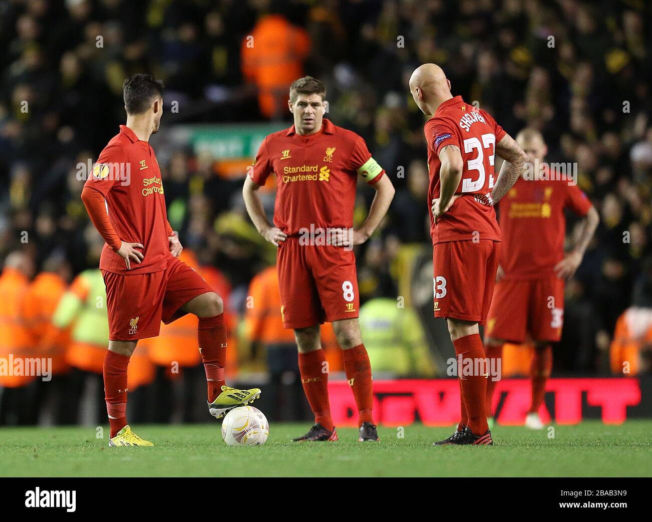 Liverpool's Steven Gerrard (centre), Jonjo Shelvey (right) and Jesus Fernandez Saez (left) wait to restart the match after Young Boy's Raul Marcelo Bobadilla (not in picture) scored his team's opening goal Stock Photo