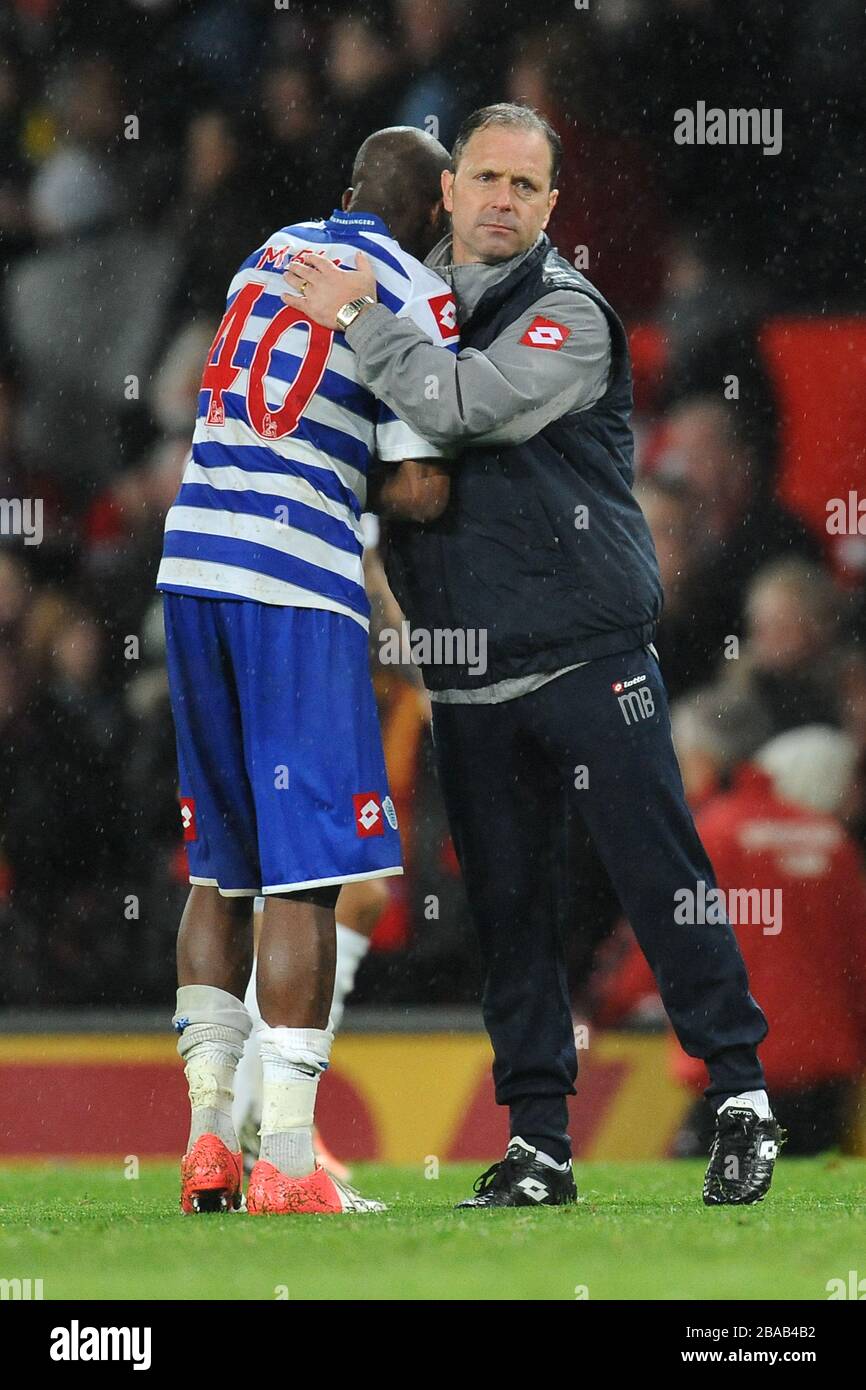 Queens Park Rangers' Mark Bowen consoles Stephan Mbia at the end of the game Stock Photo