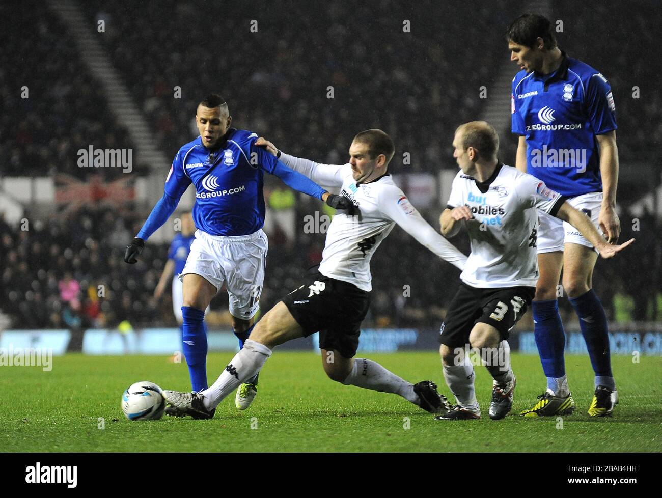 Derby County's Jake Buxton (right) tackles Birmingham City's Ravel Morrison (left). Stock Photo