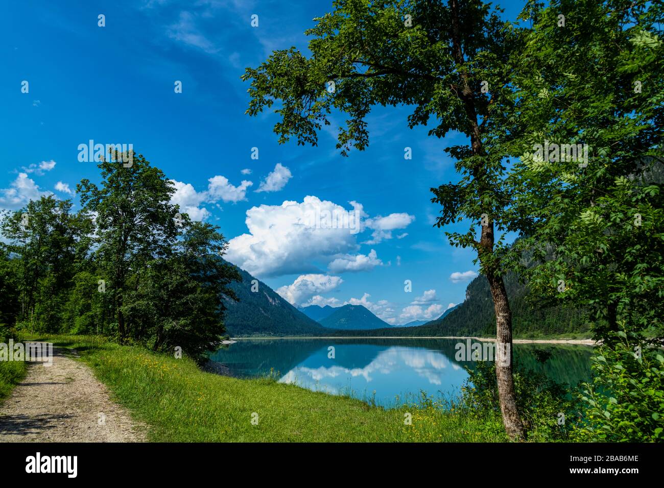Scenic landscape with footpath along Sylvenstein lake in springtime, Lenggries, Bavaria, Germany Stock Photo