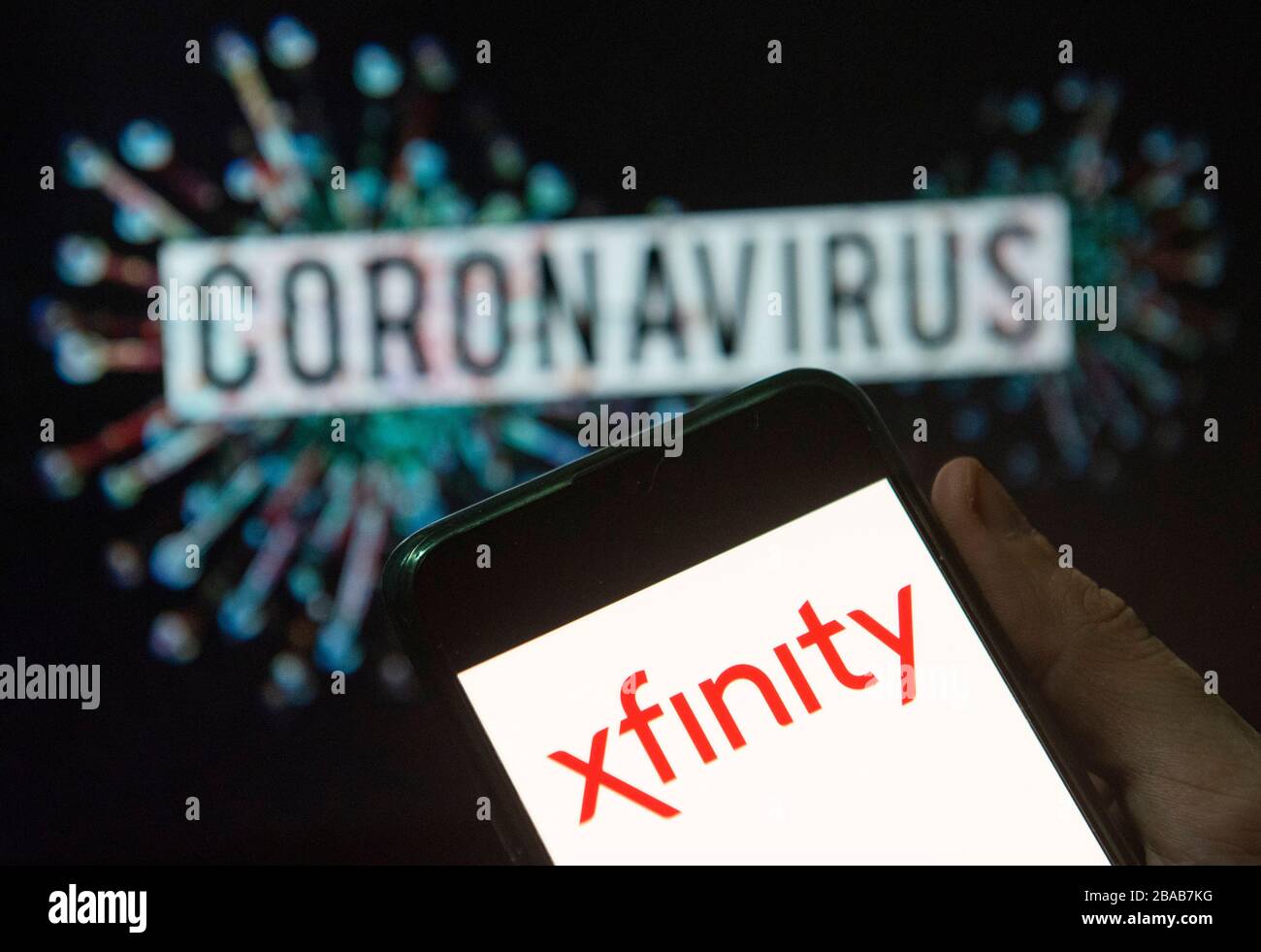 China. 24th Mar, 2020. In this photo illustration the American Internet television service provider owned by Comcast, Xfinity, logo seen displayed on a smartphone with a computer model of the COVID-19 coronavirus on the background. Credit: Budrul Chukrut/SOPA Images/ZUMA Wire/Alamy Live News Stock Photo