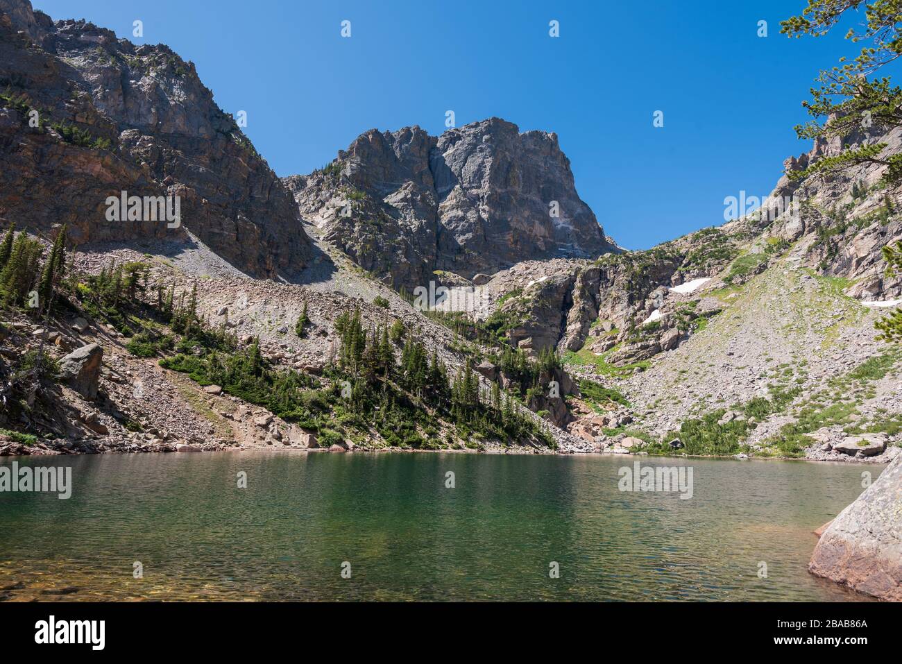 Landscape of jagged mountain peaks and Emerald Lake in Rocky Mountain National Park in Colorado Stock Photo