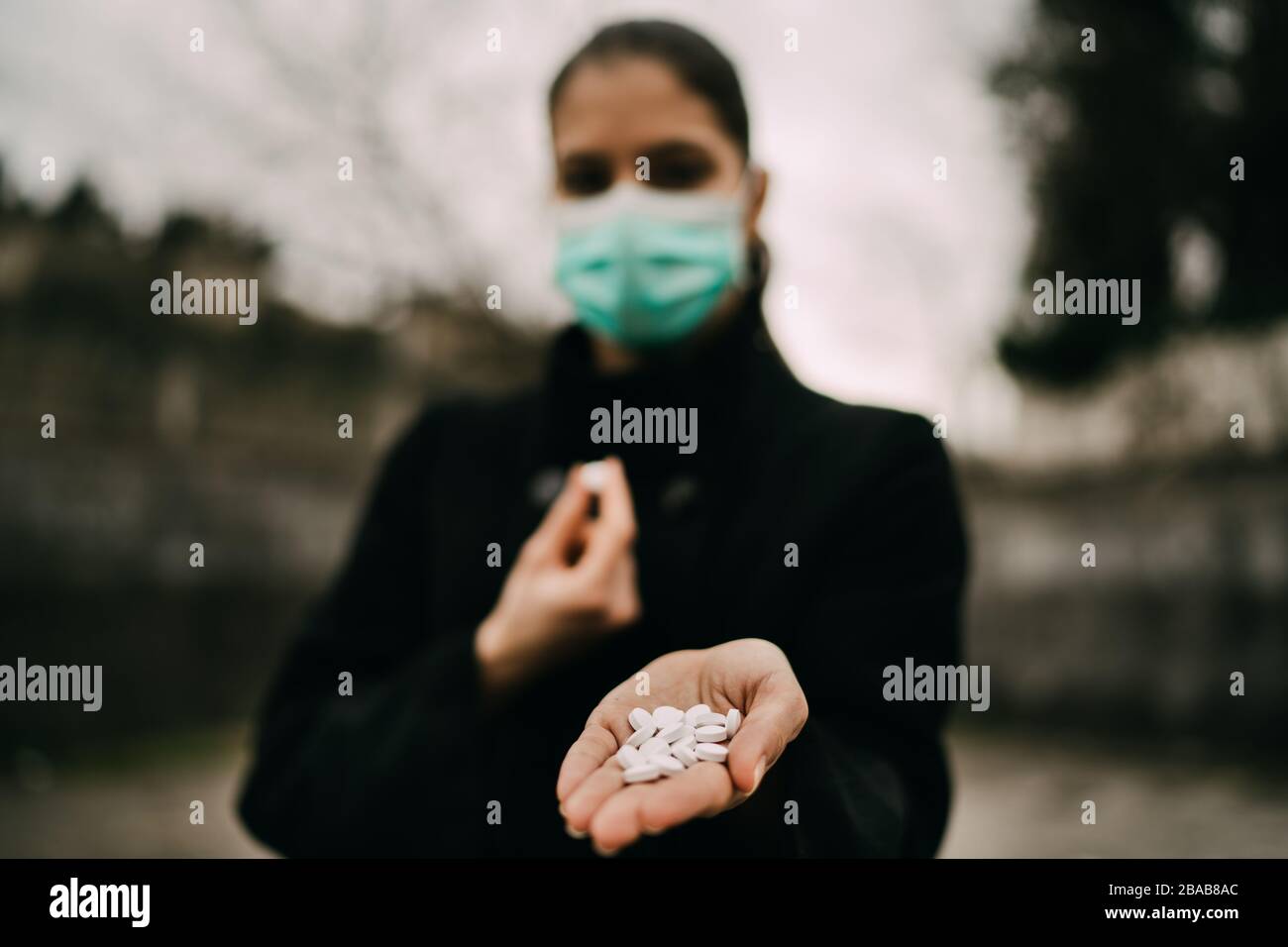 Person in mask offering medication.Dealing prescribed medication.Infected with virus/bacteria.Viral outbreak.Infection disease prevention and control. Stock Photo