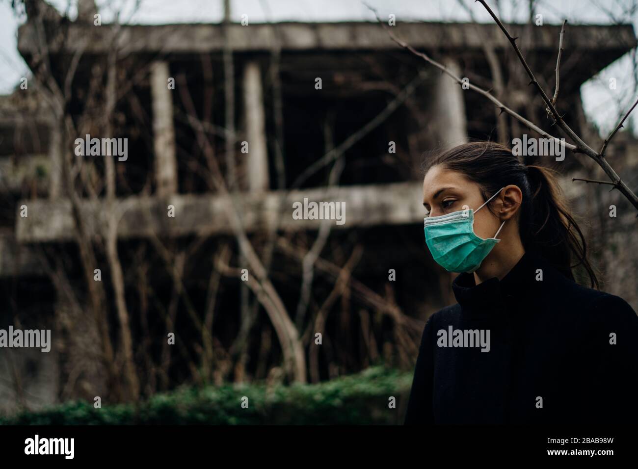 Sick woman wearing hygienic protective mask.Respiratory system infectious disease victim.Lethal lung disease.Attacked immune system.Viral fever.Desper Stock Photo