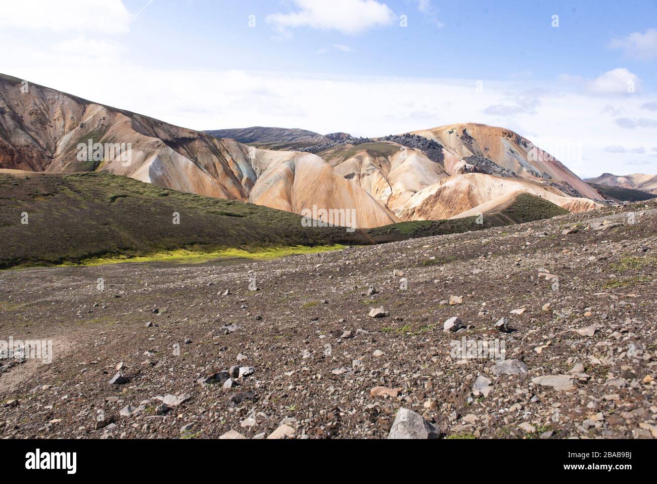 Man walking on top of grassy hill in the highlands of Iceland Stock Photo