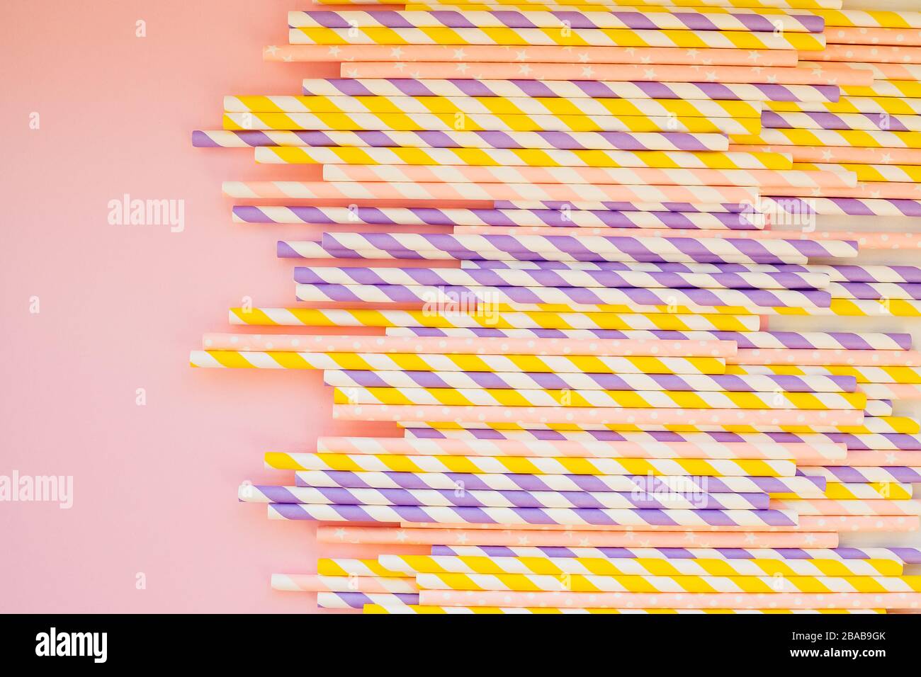 Drinking paper colorful straws for summer cocktails on light pastel background with copy space. Eco friendly Reusable Straws. Paper cocktail tubes Stock Photo