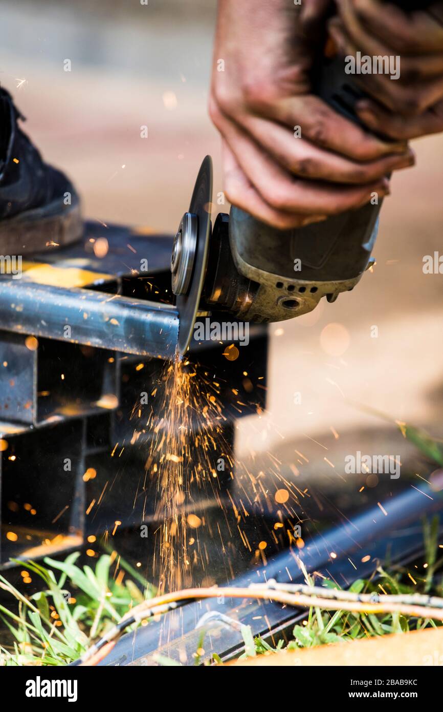 Closeup of skilled worker using angle grinder to cut steel Stock Photo Alamy