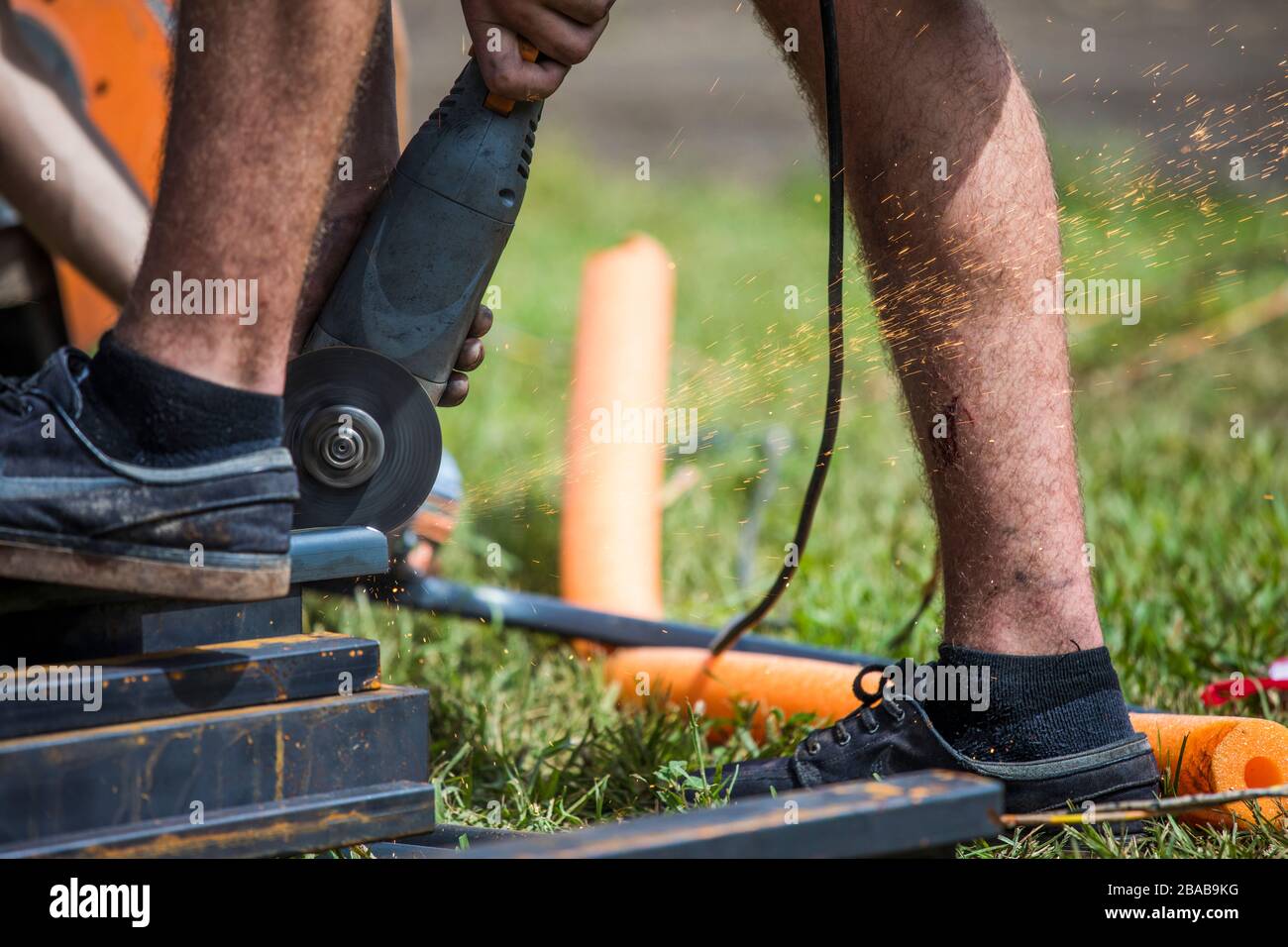 Worker using angle grinder to cut steel Stock Photo Alamy