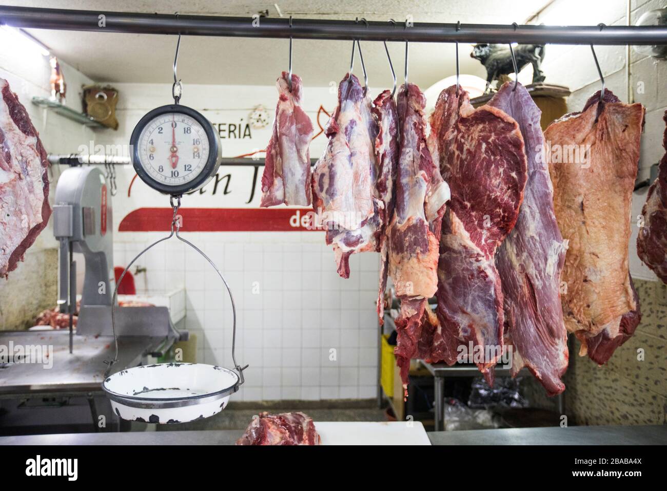 Meat and scale hanging on display at market butcher shop Stock Photo - Alamy