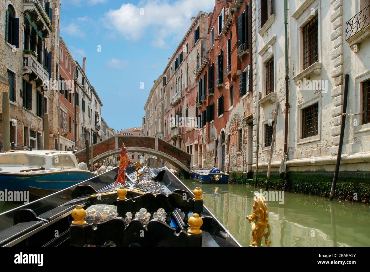 View while riding in a gondola down a small side canal with buildings on both sides. Venice, Italy. Stock Photo