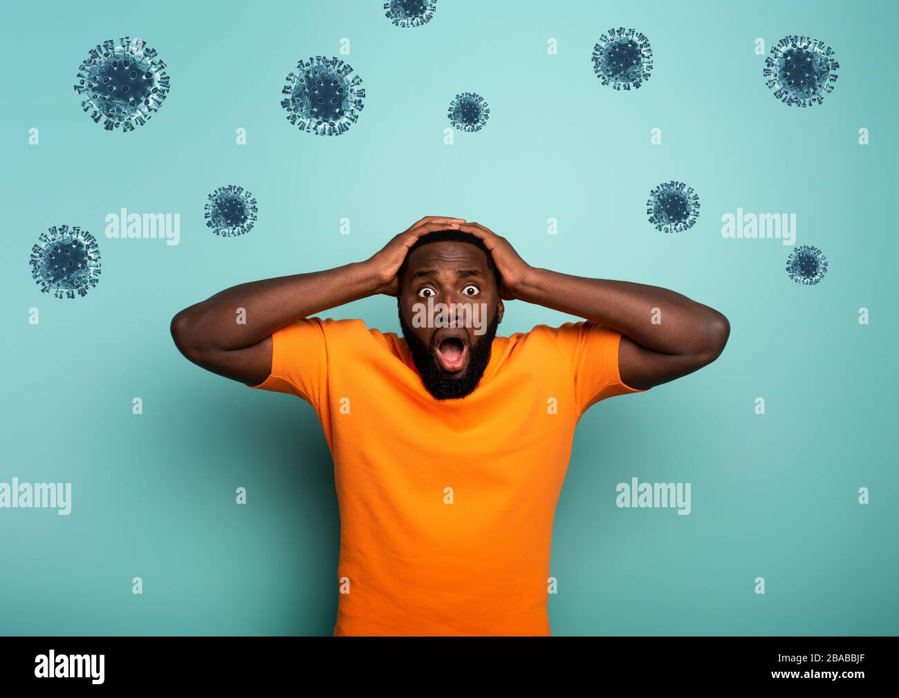 Fearful expression of a boy who is scared to catch the coronavirus. Cyan background Stock Photo