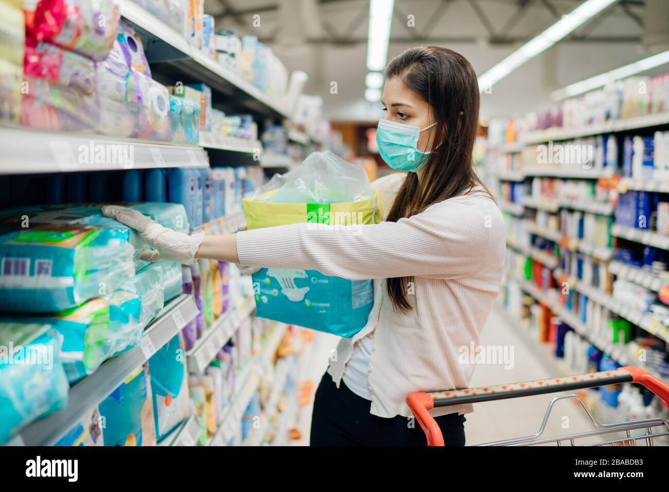 Woman shopper with mask and gloves panic buying and hoarding disposable
