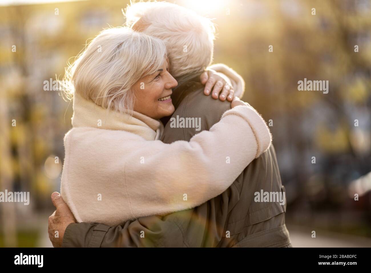 Senior couple hugging outdoors in autumn Stock Photo