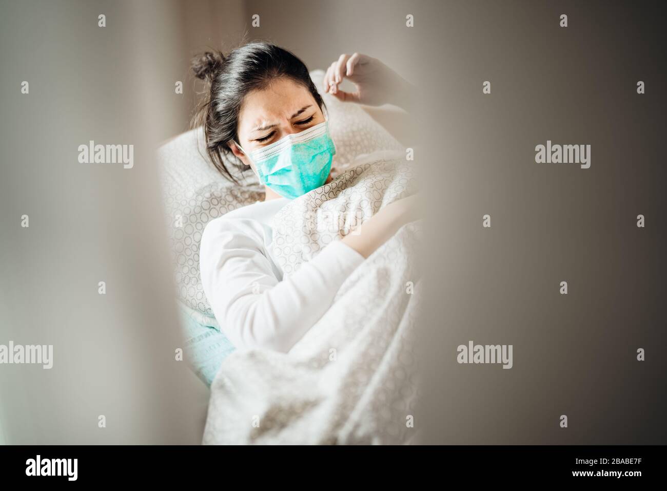 Sick woman with mask in mobile quarantine hospital units isolation.Coronavirus Covid-19 patient having pneumonia disease symptoms.Cough Stock Photo
