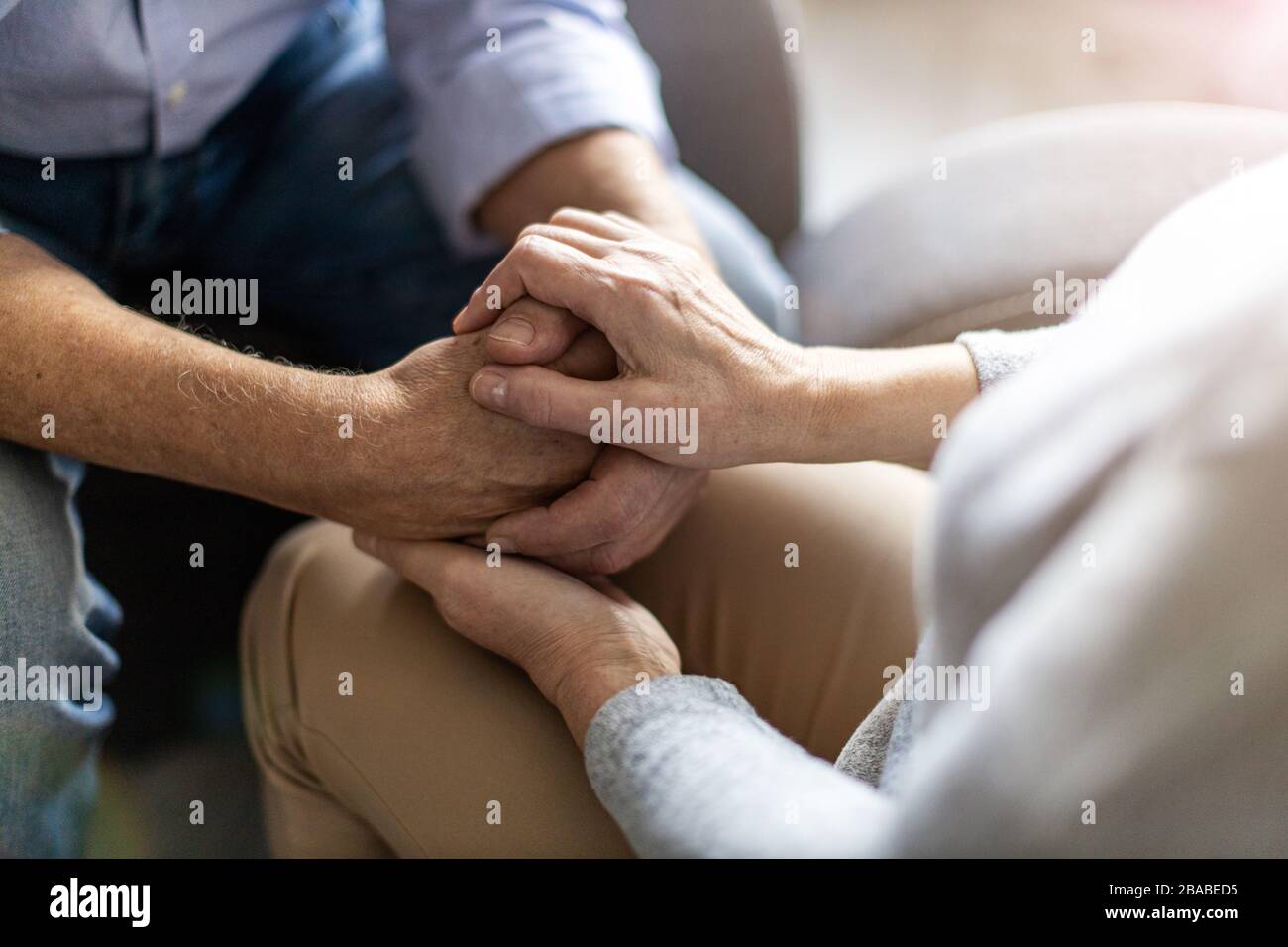 Close up of senior couple holding hands Stock Photo