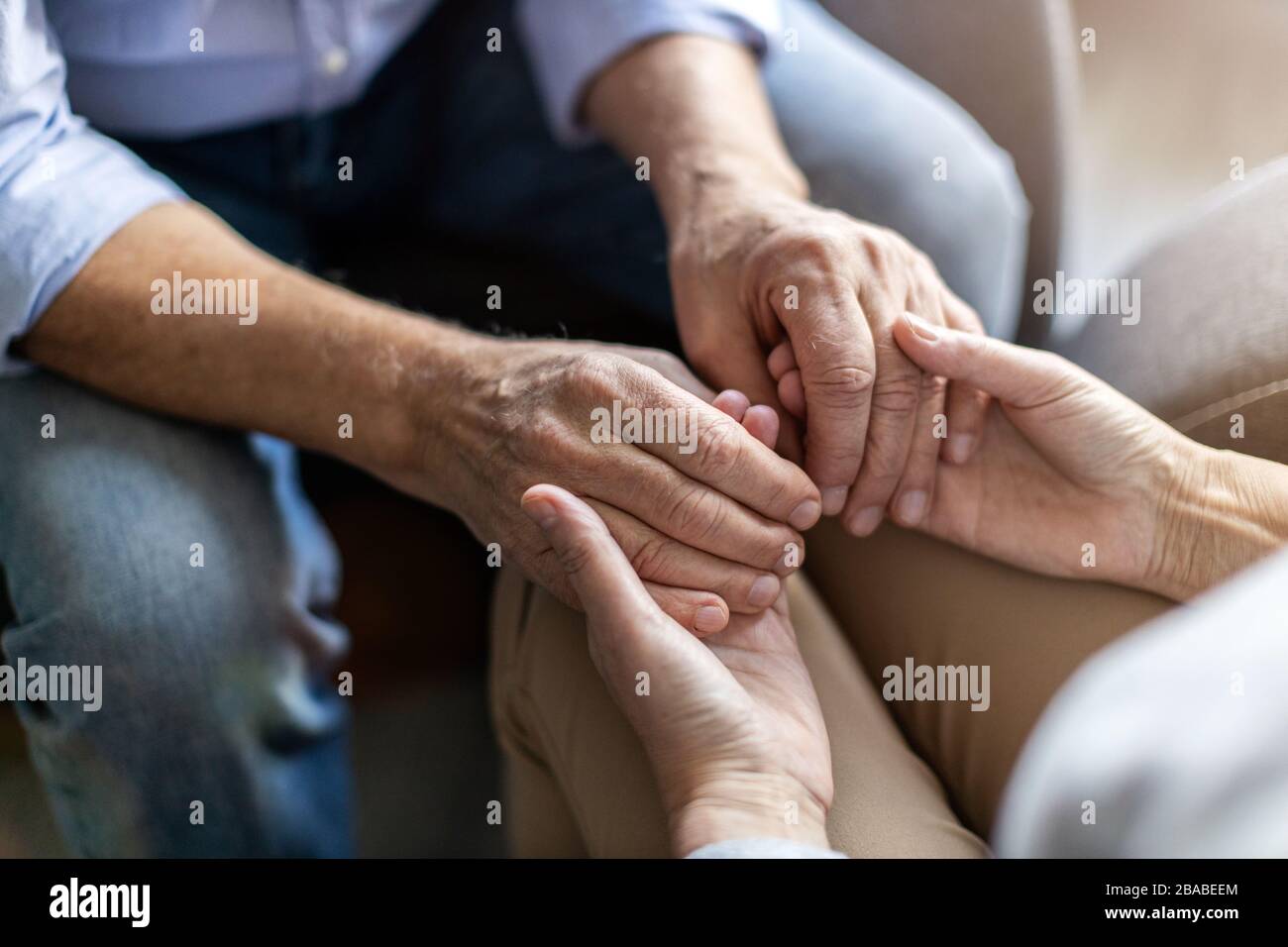 Close up of senior couple holding hands Stock Photo