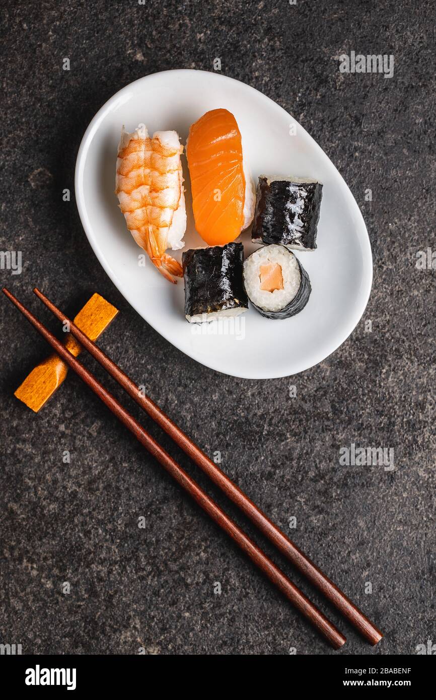 Japanese sushi food. Maki and nigiri roll sushi with salmon, caviar, avocado and tuna. Top view. Stock Photo