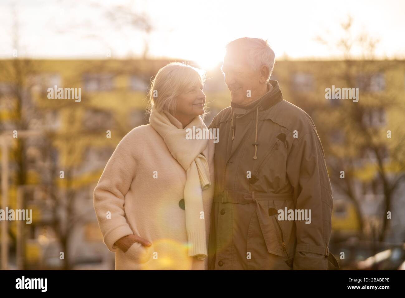 Senior couple hugging outdoors in autumn Stock Photo