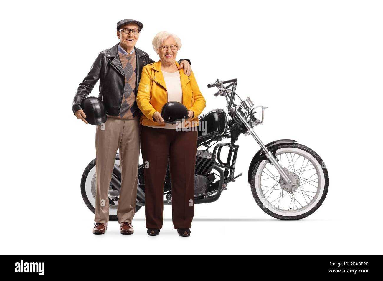 Full length portrait of a senior couple standing next to a custom made chopper motorbike isolated on white background Stock Photo
