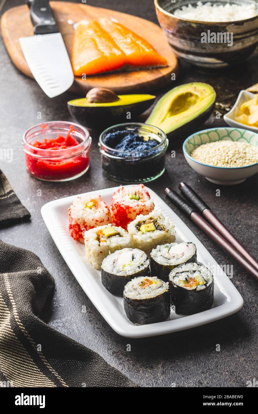 Japanese sushi food. Maki and california roll sushi with salmon, caviar, avocado, tuna and wasabi with ginger. Stock Photo