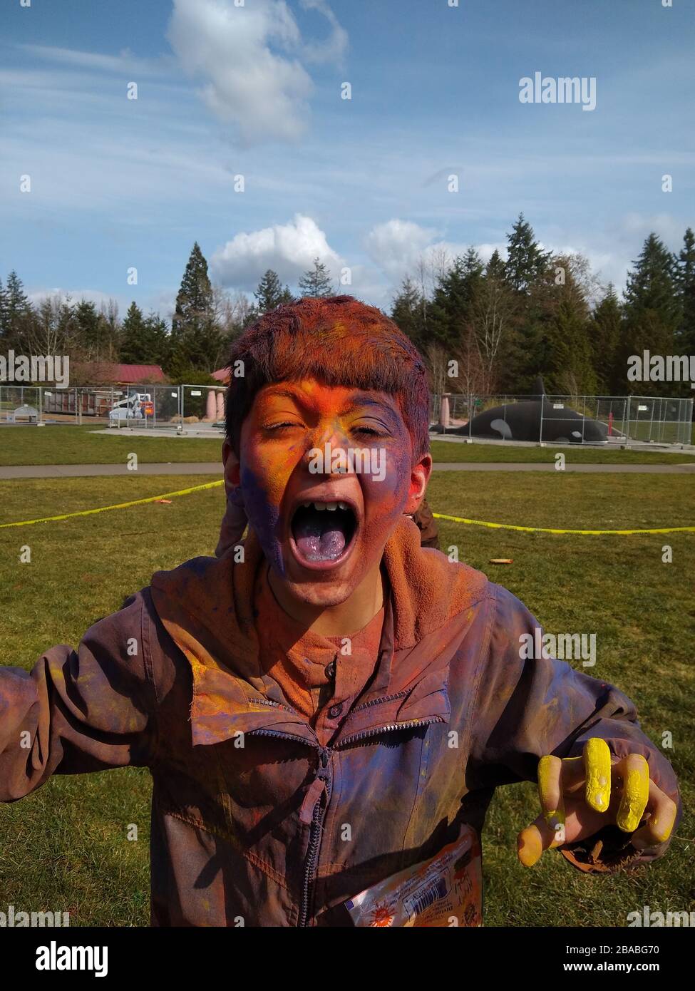 Potrait of excited boy with colored face playing Holi Stock Photo