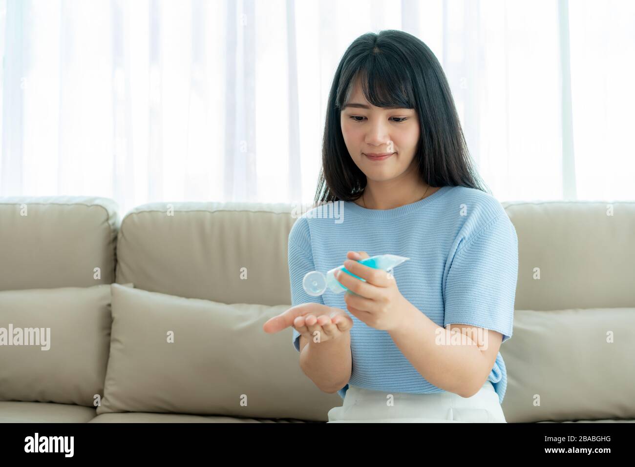 Asian womanl using alcohol antiseptic gel, prevention, cleaning hands frequently, prevent infection, outbreak of Covid-19 wash hands with hand sanitiz Stock Photo