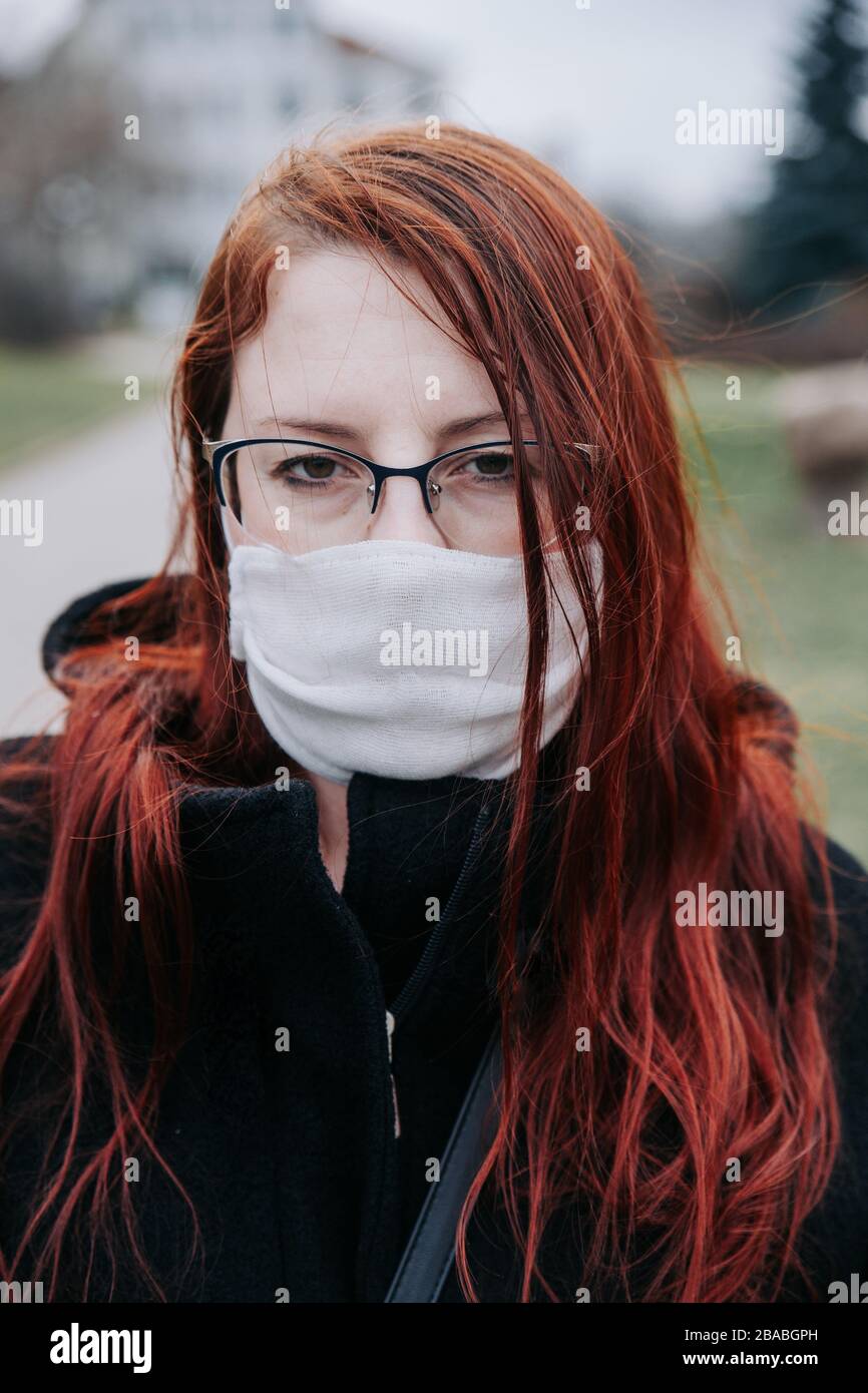 Woman in city street wearing face mask protective for spreading of disease virus Stock Photo