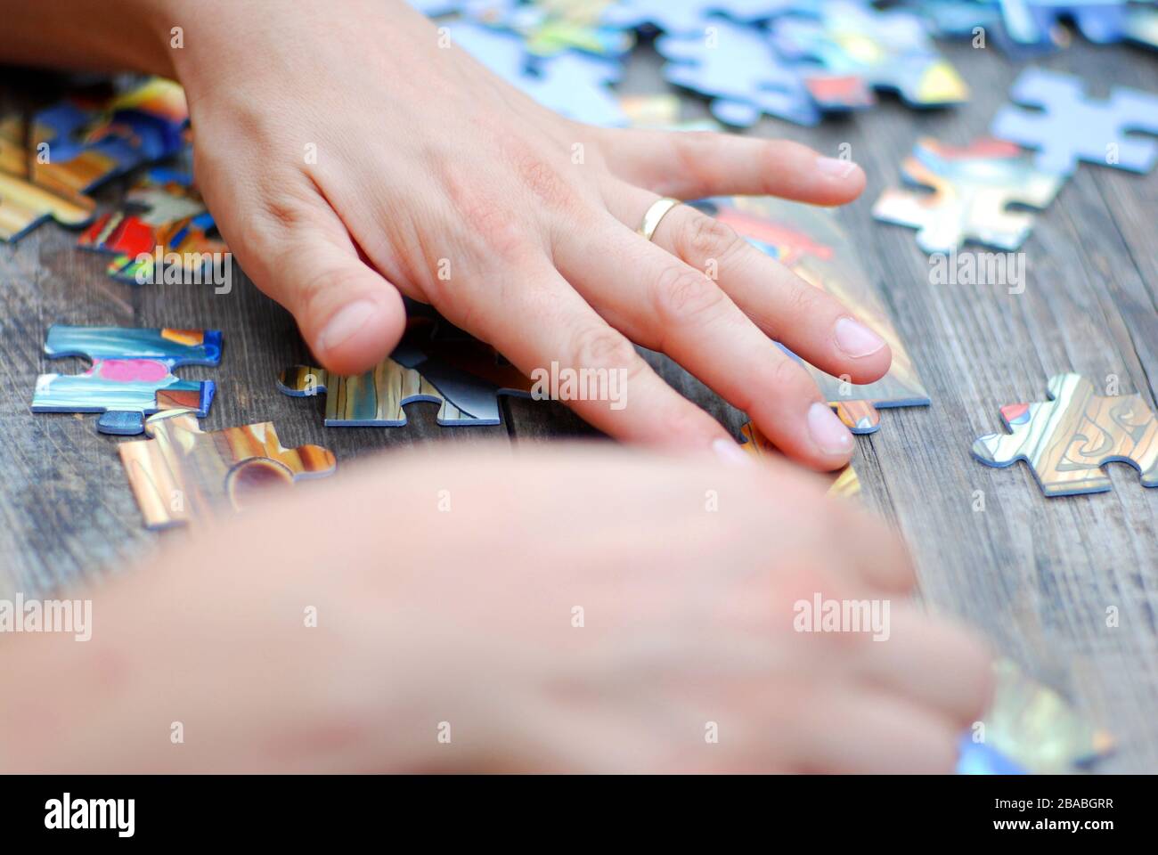 Hands on a puzzle game Stock Photo