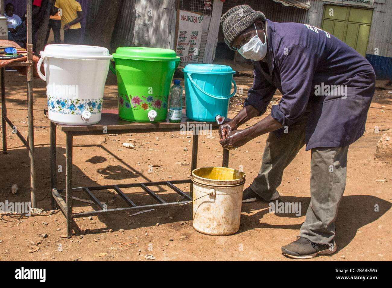 Nairobi, Kenya. 25th Mar, 2020. A local business man provides passers