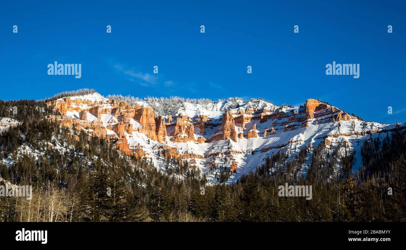 Snow among red rock cliffs and hoodoo towers of the Southwest desert in Utah. Red sandstone formations in winter. Stock Photo