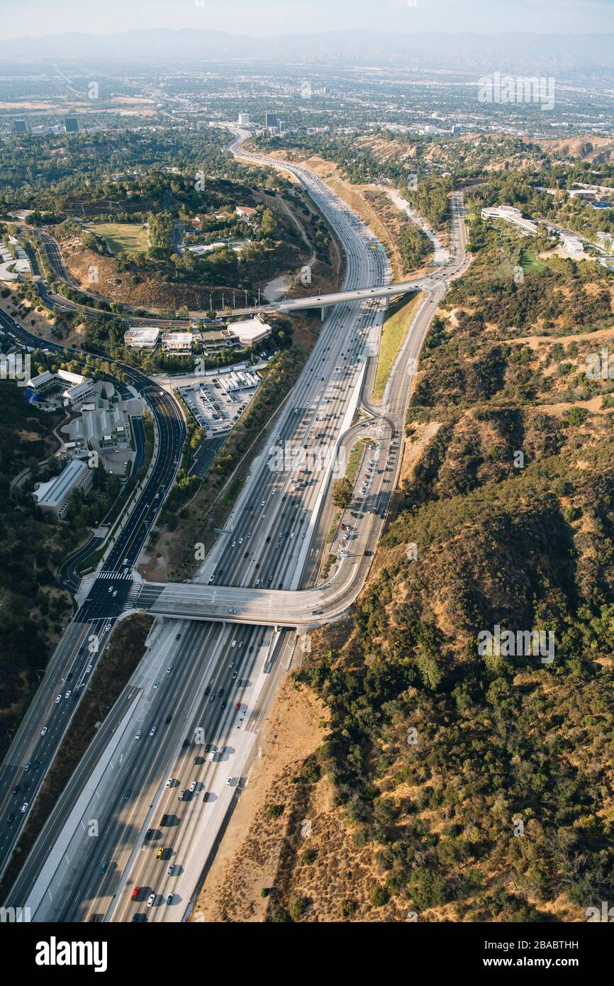 Freeway Low View Aerial view of freeway between mountains on Los Angeles, California ...