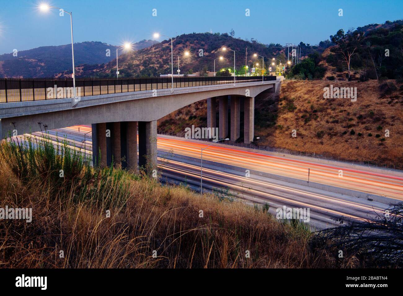 View of bridge over freeway overpass at night on Los Angeles, California, USA Stock Photo