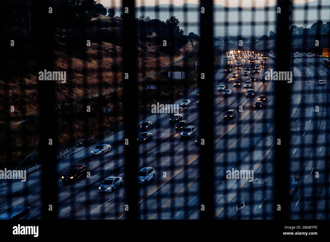 View for freeway from freeway overpass from behind net at Los Angeles, California, USA Stock Photo