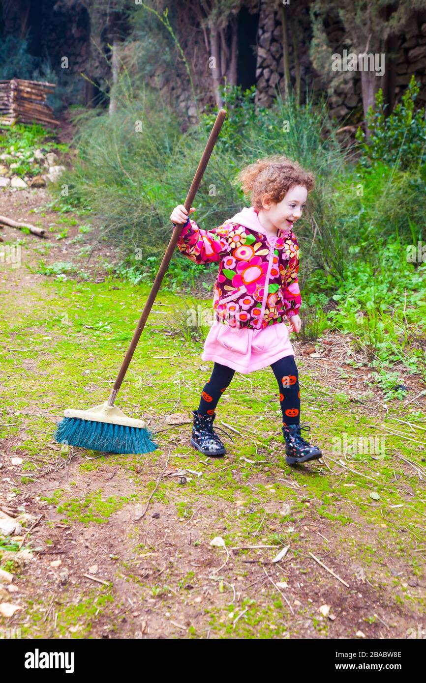 https://c8.alamy.com/comp/2BABW8E/joyful-little-girl-sweeping-broom-in-house-backyard-2BABW8E.jpg