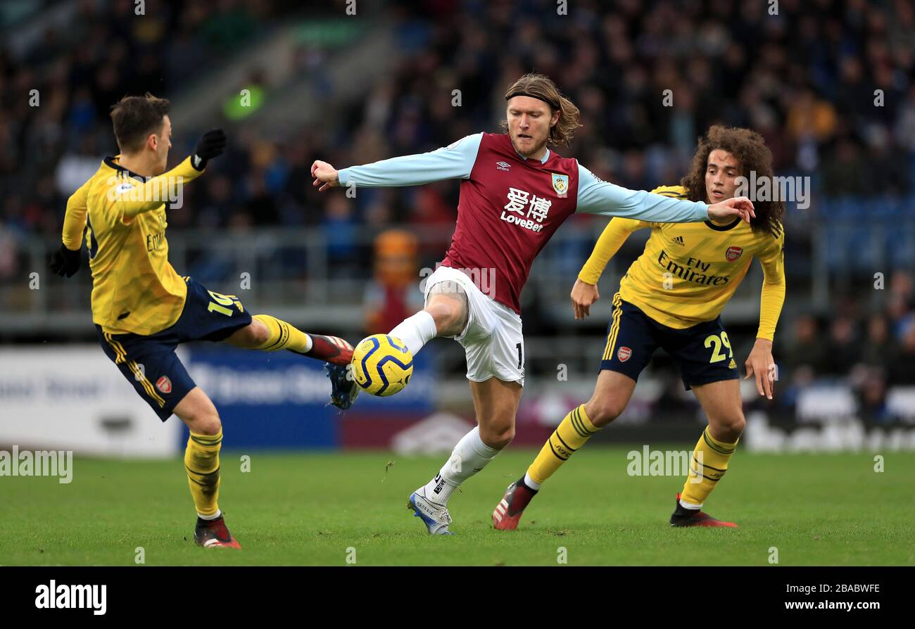 Burnley's Jeff Hendrick (centre) in action with Arsenal's Mesut Ozil (left) and Matteo Guendouzi during the Premier League match at Turf Moor, Burnley. Stock Photo