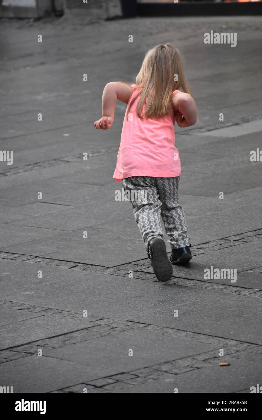 Little Girl Rushing Caught movement in little girl's race Stock Photo - Alamy