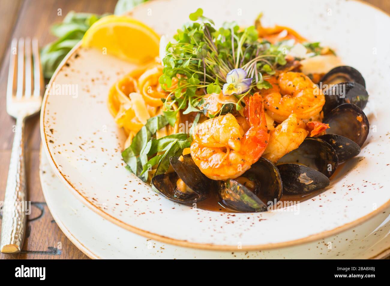seafood fettuccine with sauteed white prawns, mussels and fish Stock