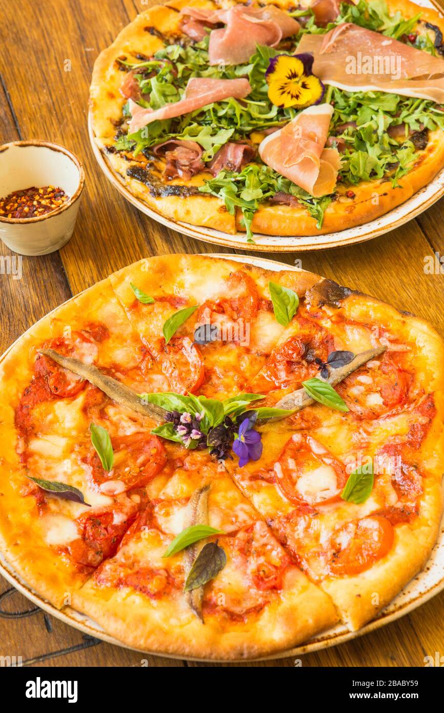 margherita pizza and a proscuitto and arugula pizza Stock Photo