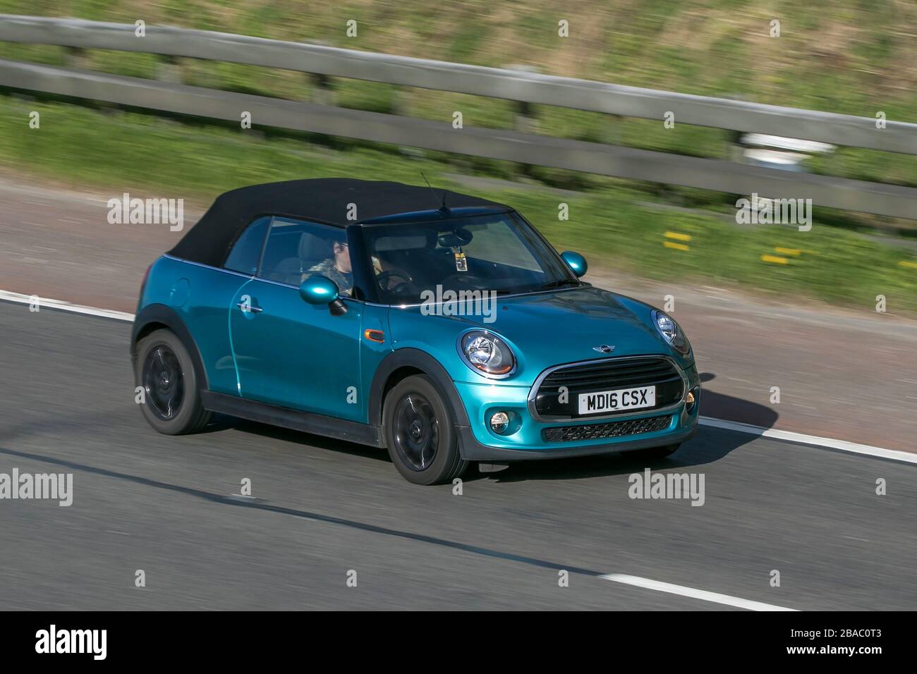 Mini convertible cabriolet 2016 Cooper Turquoise Car Petrol driving on the M6 motorway near Preston in Lancashire, UK Stock Photo