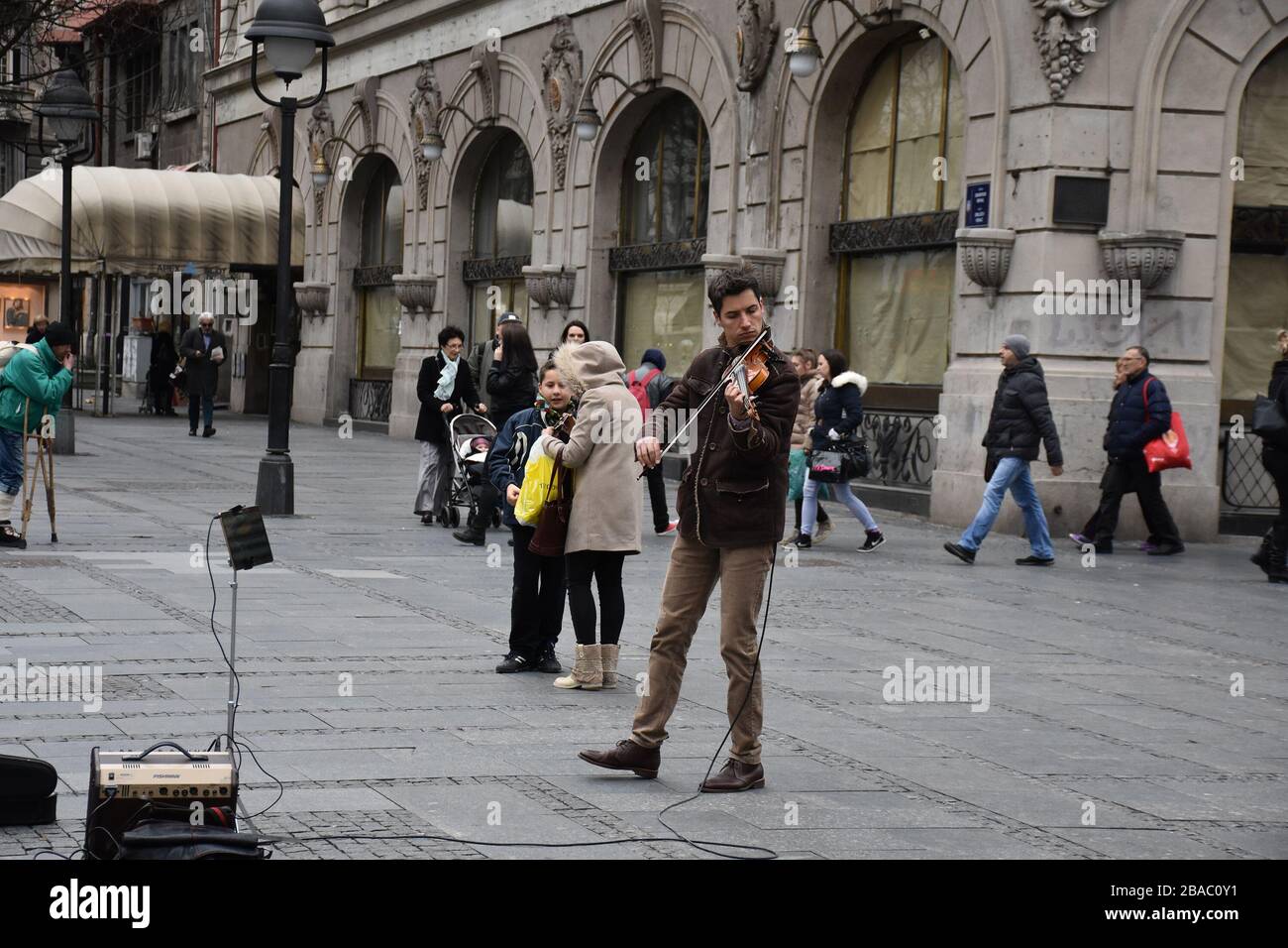 The young man in the brown suit is a street player on Knez Mihailova Street in Belgrade Stock Photo