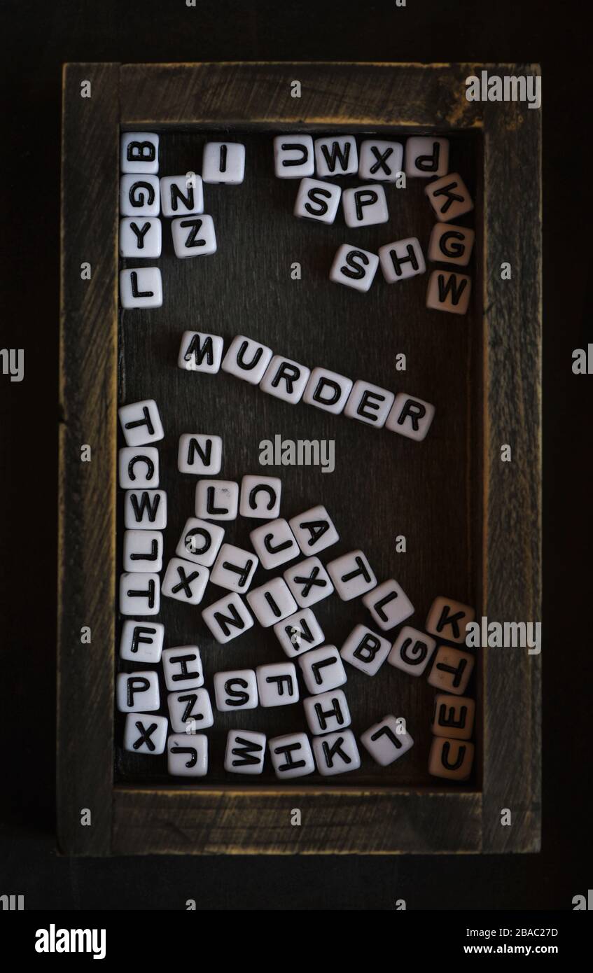 Still life showing black and white letter blocks spell out the word