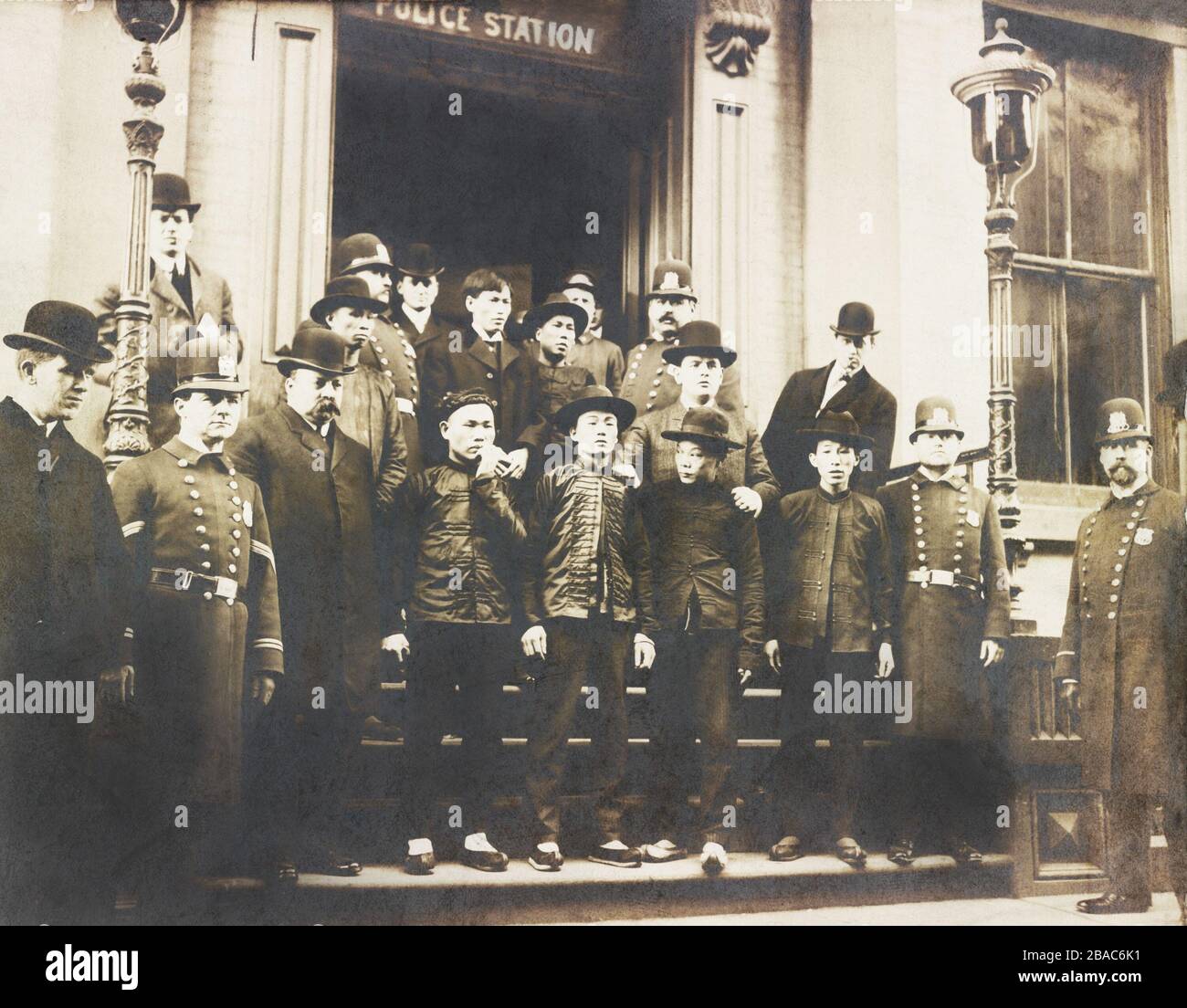 ChineseAmerican men standing outside NYC Police station with officers