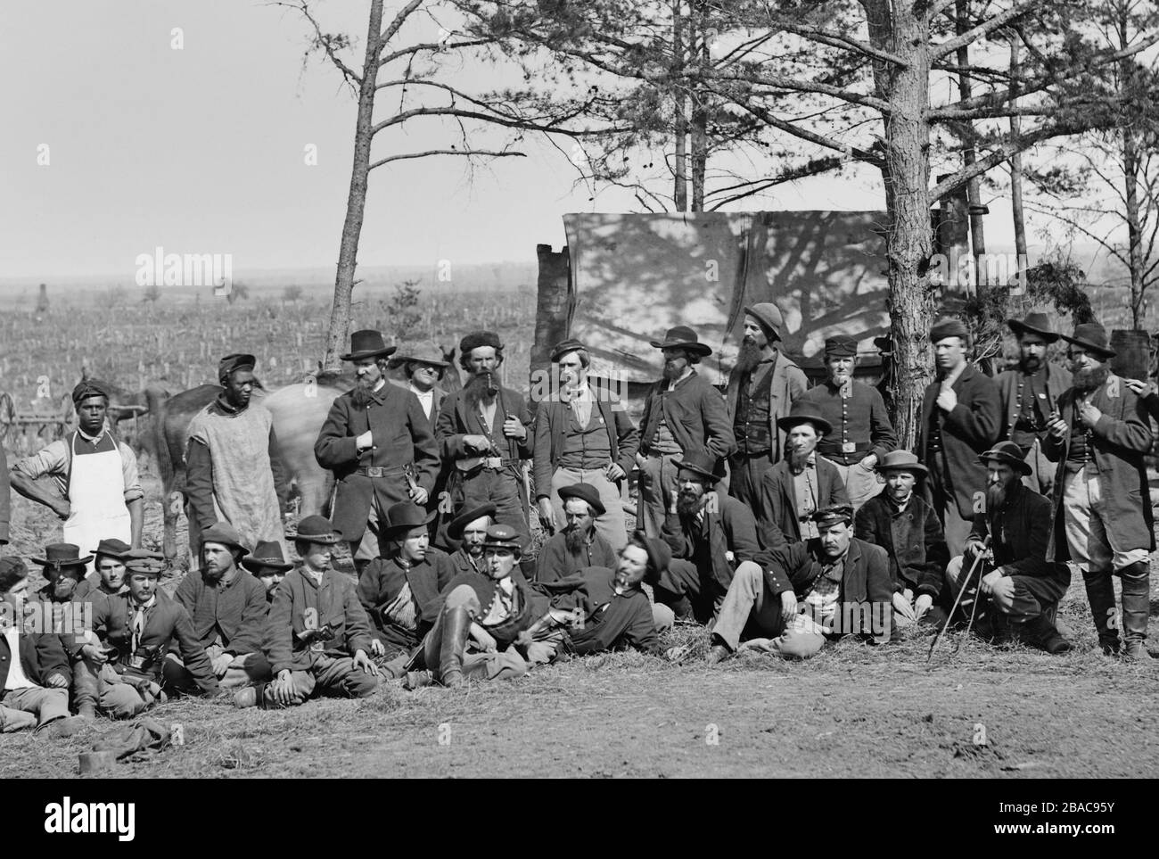 Union scouts and guides of the Union Army of the Potomac, at winter quarters, Brandy Station, March 1864. These men were part of the Bureau of Military Intelligence, headed by Gen. George Sharpe. The men wear a variety of clothing to fade in with the general population as they gather military information  (BSLOC 2019 2 149) Stock Photo
