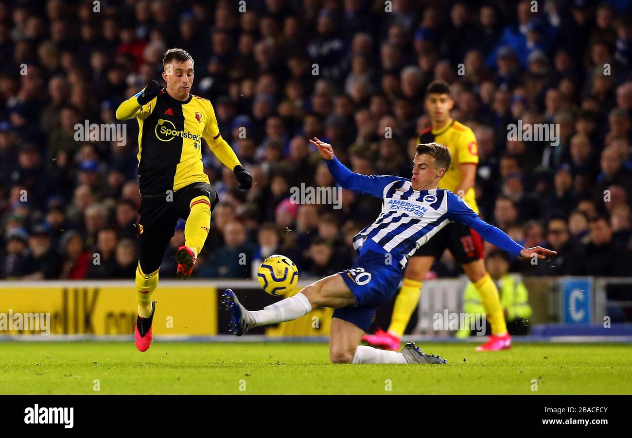 Watford's Gerard Deulofeu (left) and Brighton and Hove Albion's Solly March battle for the ball Stock Photo