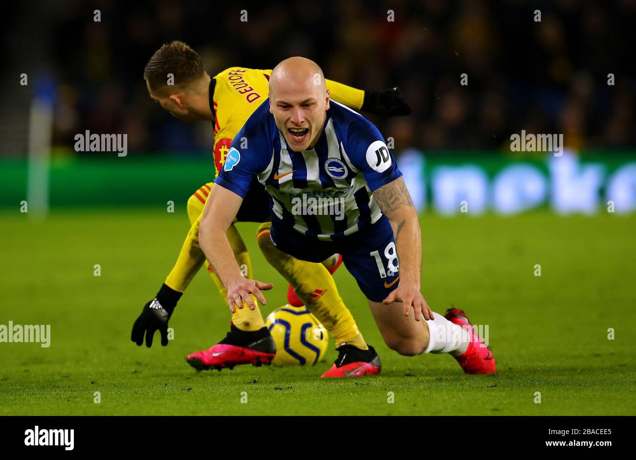 Brighton and Hove Albion's Aaron Mooy goes down under the challenge from Watford's Gerard Deulofeu Stock Photo
