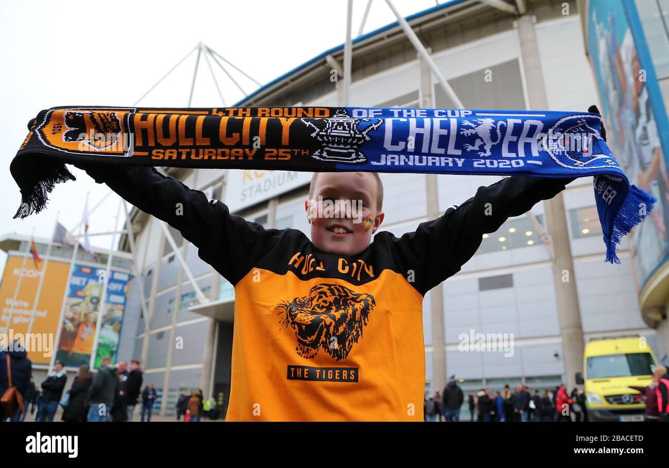 A Hull City fan holding up the match day scarf Stock Photo