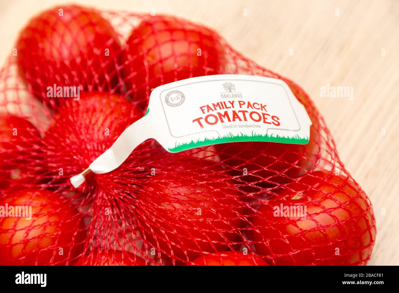 Fresh tomatoes in plastic netting bag from Lidl Stock Photo Alamy