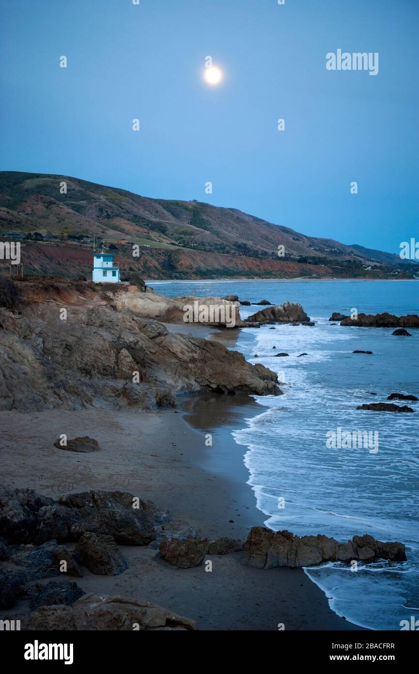 Full moon rising over the southern California coast at Malibu, CA. Stock Photo